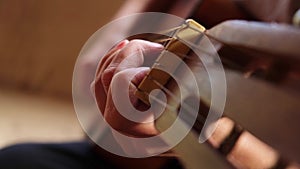 Woman hands playing classical acoustic guitar, closeup. Music concept. Girl learning to play song and writing music