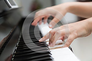 woman hands playing piano