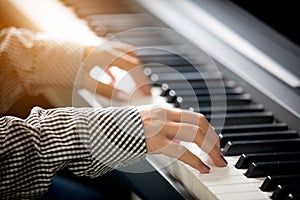 woman hands playing piano