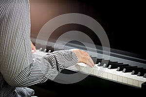 Woman hands playing piano