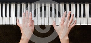 Woman hands playing piano music.