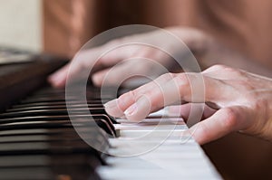 Woman hands playing piano music.