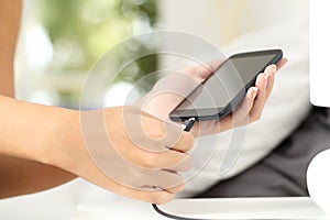 Woman hands plugging a charger in a smart phone photo