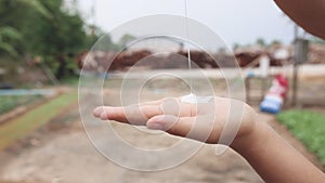 Woman hands pouring sunscreen cream on hand.