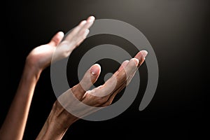 Woman hands praying with black background