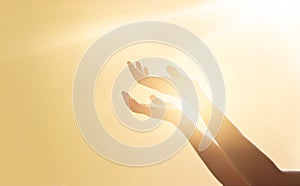 Woman hands praying for blessing from god on sunset background