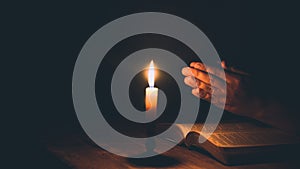 Woman hands praying on holy bible