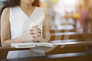 Woman hands praying on a holy bible in church for faith concept, Spirituality and Christian religion