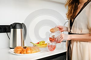 Woman hands prepare breakfast tea and food