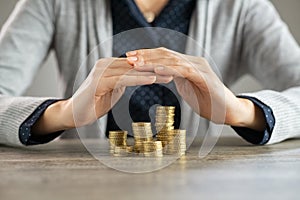 Woman hands protecting savings