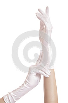 Woman hands pull on white gloves. isolated on white background
