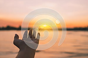 Woman hands reach out to the sky like praying in front of sky