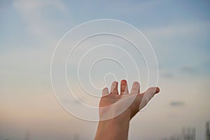 Woman hands reach out to the sky like praying in front of sky.