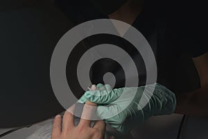 Woman hands receiving a manicure in beauty salon. Nail filing. Close up, selective focus