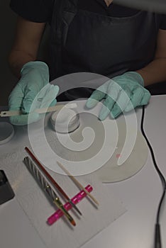 Woman hands receiving a manicure in beauty salon. Nail filing. Close up, selective focus