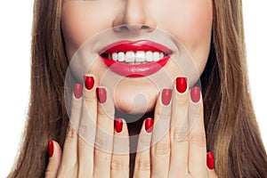 Woman hands with red manicured nails and red lips makeup