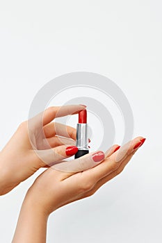 Woman Hands with Red Nail Polish and Red Lipstick on a White Background