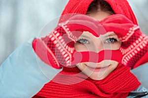 Woman hands in red winter gloves. Heart symbol shaped Lifestyle and Feelings concept.