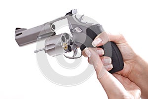 Woman hands with revolver with last shell