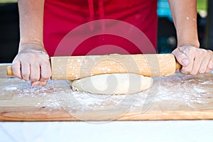 Woman hands rolling dough