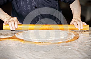 Woman hands rolling out dough