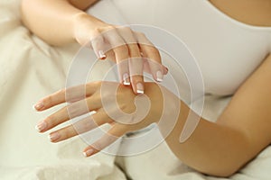 Woman hands rubbing moisturizer cream