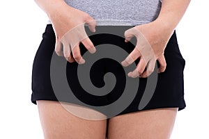 Woman hands scratching her crotch  white background. Medical, healthcare for advertising concept photo