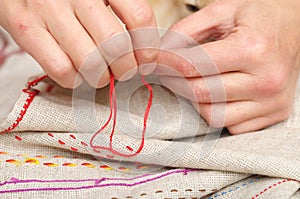 Woman hands sewing with muline
