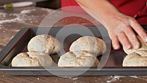 Woman hands shaping the dough making buns