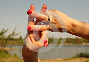 Woman hands showing hash symbol against the backdrop of summer w