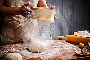 Woman hands sifting flour