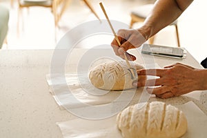 Woman preparing sourdough bread at home