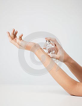 Woman hands spraying perfume