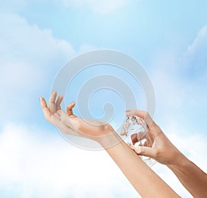 Woman hands spraying perfume