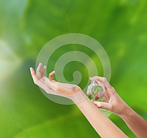 Woman hands spraying perfume