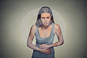 Woman hands on stomach having bad aches pain