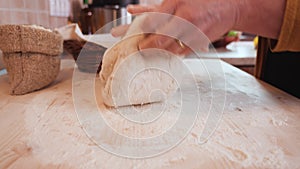 Woman hands stretch and fold the bread dough