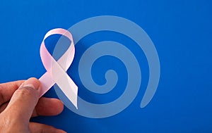 Woman hands and supporting Pink ribbon symbol of breast cancer. Breast Cancer concept