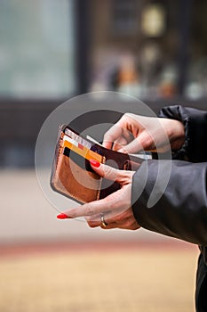 Woman hands taking money out of leather wallet
