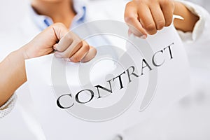 Woman hands tearing contract paper