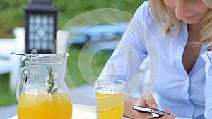 Woman hands texting on smartphone during breakfast in cafe