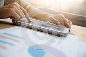 Woman hands touching on digital tablet screen.