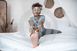 Woman with hands touching her toes