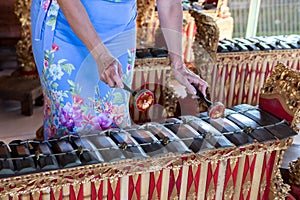 Woman hands and Traditional Balinese music instrument gamelan. Bali island, Indonesia.