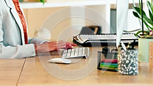 Woman hands typing on computer keyboard. Closeup of a businesswoman doing office admin. Female entrepreneur clicking and