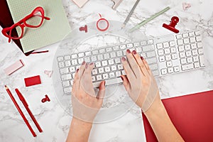 Woman hands typing on the keyboard. top view, flat lay. Online shopping, social networking, internet surfing, online blog idea