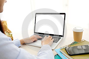 Woman hands typing laptop computer with blank screen for mock up