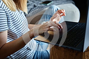 Woman hands typing on laptop keyboard