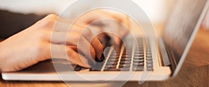 Woman hands typing on laptop keyboard at business meeting