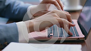 Woman hands typing laptop keyboard at office workplace close up. Worker writing